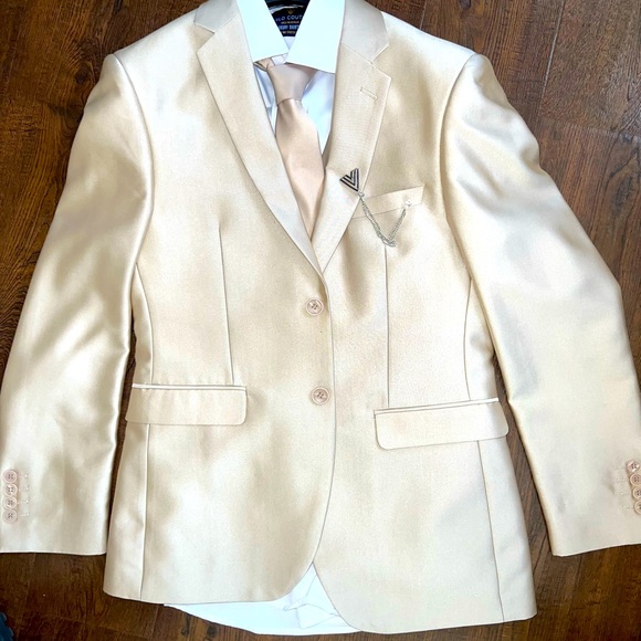 Suit set includes tuxedo tie pants and white shirt.